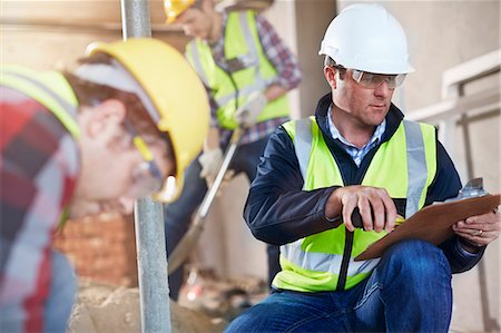 simsearch:6113-08321783,k - Foreman with clipboard at construction site Stock Photo - Premium Royalty-Free, Code: 6113-08321771