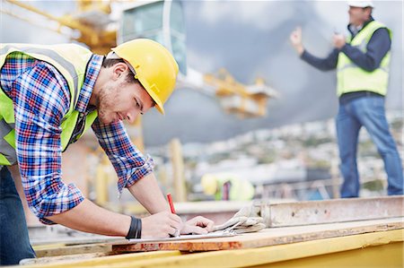 simsearch:6113-08321783,k - Construction worker writing on clipboard at construction site Stock Photo - Premium Royalty-Free, Code: 6113-08321776