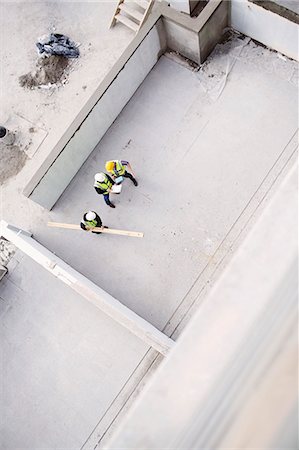 protective workwear - Overhead view of construction workers at construction site Stock Photo - Premium Royalty-Free, Code: 6113-08321783
