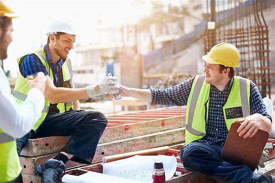 Construction workers and engineer enjoying coffee break at construction site Stock Photo - Premium Royalty-Free, Image code: 6113-08321724