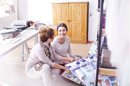 person crouching looking down - Interior designers browsing fabric swatches in office Stock Photo - Premium Royalty-Free, Code: 6113-08424137