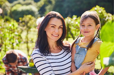 simsearch:632-02416107,k - Portrait smiling mother and daughter hugging in sunny garden Stock Photo - Premium Royalty-Free, Code: 6113-08424228