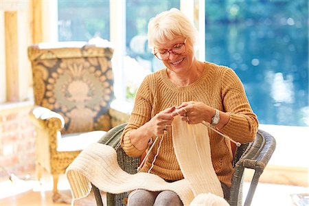 sitting knitting - Senior woman knitting in living room Stock Photo - Premium Royalty-Free, Code: 6113-08424233
