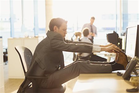 funny office chairs pictures - Businessman stretching feet on desk in office Stock Photo - Premium Royalty-Free, Code: 6113-08549943