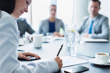 simsearch:632-08886926,k - Businesswoman reviewing paperwork in conference room meeting Stock Photo - Premium Royalty-Free, Code: 6113-08549998