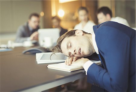 simsearch:6113-08549934,k - Businessman sleeping in conference room meeting Photographie de stock - Premium Libres de Droits, Code: 6113-08549937