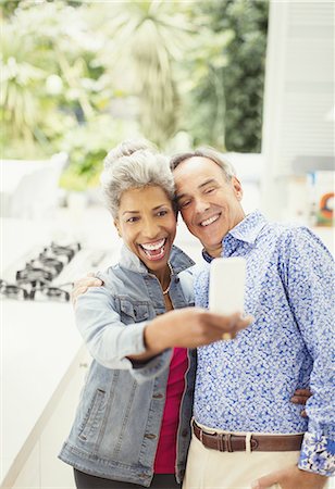 Enthusiastic mature couple taking selfie Stock Photo - Premium Royalty-Free, Code: 6113-08550053