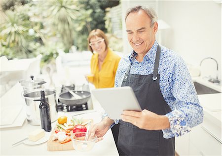 simsearch:6113-08550102,k - Mature couple with digital tablet cooking in kitchen Stock Photo - Premium Royalty-Free, Code: 6113-08550090