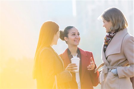 real people woman coffee - Businesswomen with coffee talking outdoors Stock Photo - Premium Royalty-Free, Code: 6113-08550134