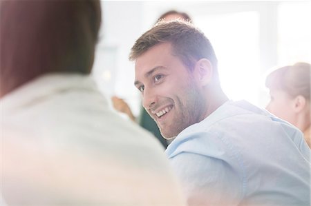 Smiling businessman listening in meeting Stock Photo - Premium Royalty-Free, Code: 6113-08568450