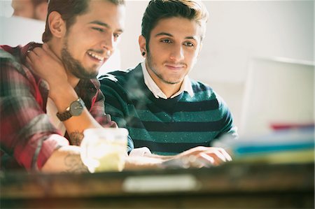 Young creative businessmen working at laptop in office Stock Photo - Premium Royalty-Free, Code: 6113-08568468