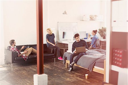 ethnically diverse college student studying with laptops or computers - Young adult friends hanging out in loft apartment Stock Photo - Premium Royalty-Free, Code: 6113-08568497