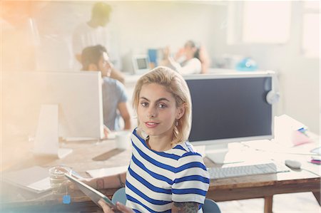 entrepreneur creative office - Portrait young adult businesswoman using digital tablet in office Stock Photo - Premium Royalty-Free, Code: 6113-08568543