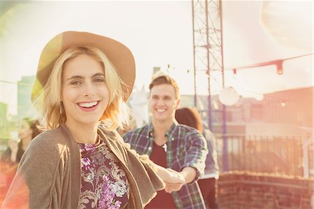 rooftop party - Portrait smiling young woman enjoying rooftop party Stock Photo - Premium Royalty-Free, Code: 6113-08568574