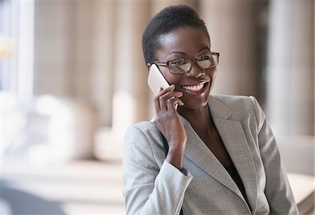 speaking with cell - Smiling corporate businesswoman talking on cell phone Stock Photo - Premium Royalty-Free, Code: 6113-08568654