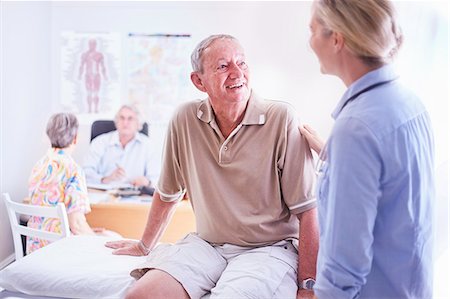 doctor comforting a patient - Doctor talking to senior man in examination room Stock Photo - Premium Royalty-Free, Code: 6113-08568773