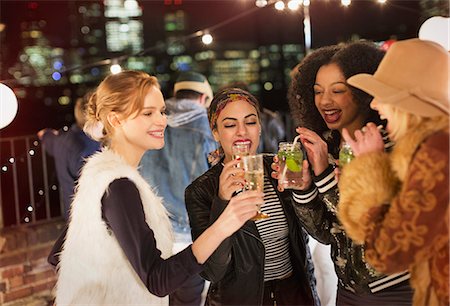 simsearch:6113-08568531,k - Young women drinking and enjoying rooftop party Stock Photo - Premium Royalty-Free, Code: 6113-08568781