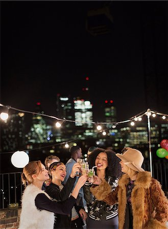 simsearch:6113-08568531,k - Young women toasting cocktails at nighttime rooftop party Stock Photo - Premium Royalty-Free, Code: 6113-08568785