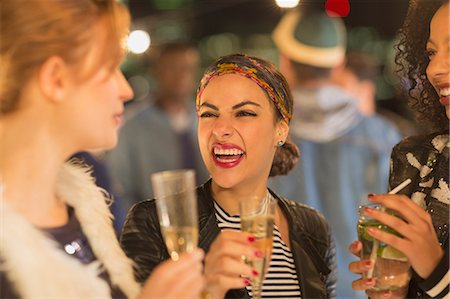 simsearch:649-07648589,k - Enthusiastic young women drinking champagne and laughing at party Stock Photo - Premium Royalty-Free, Code: 6113-08568789