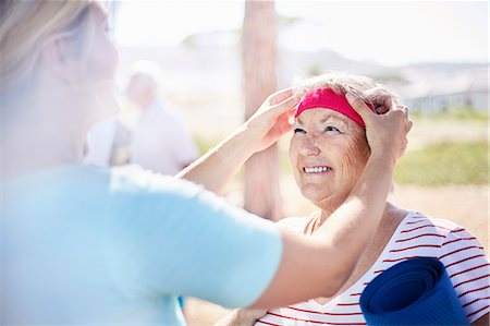 simsearch:6113-08568719,k - Yoga instructor adjusting senior woman's headband Stock Photo - Premium Royalty-Free, Code: 6113-08568726