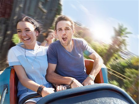 Enthusiastic young couple screaming on amusement park ride Stock Photo - Premium Royalty-Free, Code: 6113-08521343