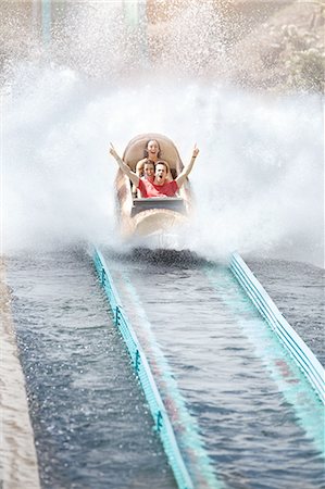 Enthusiastic friends cheering and riding water log amusement park ride Stock Photo - Premium Royalty-Free, Code: 6113-08521356