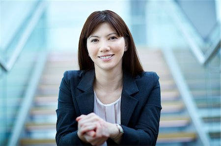 simsearch:6113-08521456,k - Portrait confident businesswoman sitting on stairs Stock Photo - Premium Royalty-Free, Code: 6113-08521385
