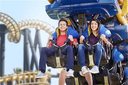 Young couple riding amusement park ride Stock Photo - Premium Royalty-Free, Code: 6113-08521311