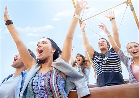 rouler - Friends cheering and riding amusement park ride Photographie de stock - Premium Libres de Droits, Code: 6113-08521316