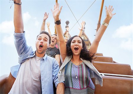 exhilarating - Portrait enthusiastic friends cheering on amusement park ride Stock Photo - Premium Royalty-Free, Code: 6113-08521333