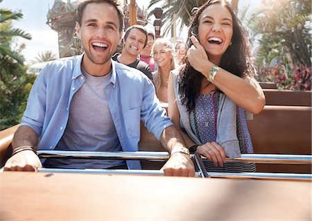 Enthusiastic young couple riding amusement park ride Stock Photo - Premium Royalty-Free, Code: 6113-08521330