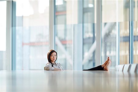 simsearch:6113-08521456,k - Portrait confident businesswoman with bare feet up on conference room table Stock Photo - Premium Royalty-Free, Code: 6113-08521456