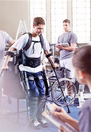 female paraplegic - Physical therapists watching man with forearm crutches standing Stock Photo - Premium Royalty-Free, Code: 6113-08521480