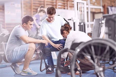 physical therapy female - Physical therapists attaching equipment to man Stock Photo - Premium Royalty-Free, Code: 6113-08521486