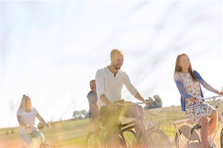 riding - Family bike riding in sunny rural field Stock Photo - Premium Royalty-Free, Code: 6113-08521547