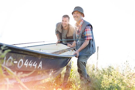 simsearch:6113-08521566,k - Father and adult son lifting fishing boat Stock Photo - Premium Royalty-Free, Code: 6113-08521518