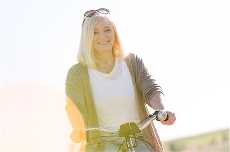 portrait middle aged woman - Portrait smiling senior woman bike riding Stock Photo - Premium Royalty-Free, Code: 6113-08521526