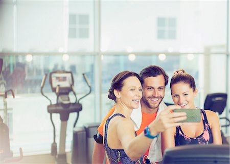 simsearch:6113-08536110,k - Smiling friends taking selfie at gym Stock Photo - Premium Royalty-Free, Code: 6113-08536019