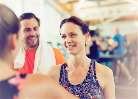 real people - Smiling friends talking in gym Stock Photo - Premium Royalty-Free, Code: 6113-08536027