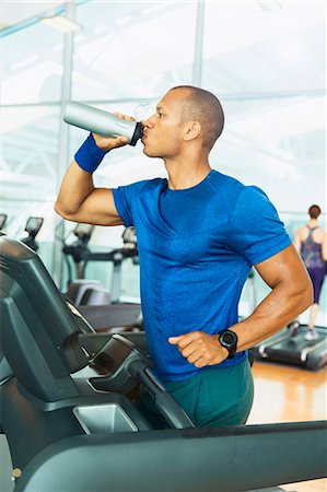 exercise in gym - Man drinking water on treadmill at gym Stock Photo - Premium Royalty-Free, Code: 6113-08536155