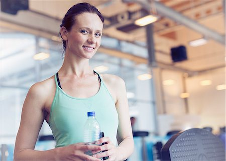 simsearch:6113-08536110,k - Portrait smiling woman drinking water at gym Stock Photo - Premium Royalty-Free, Code: 6113-08536110