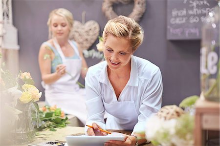 Florist using digital tablet in flower shop Stock Photo - Premium Royalty-Free, Code: 6113-08536224