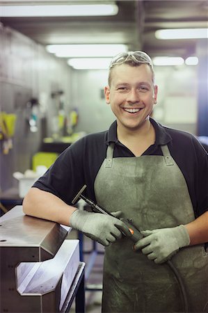 Portrait smiling worker in steel factory Stock Photo - Premium Royalty-Free, Code: 6113-08655248