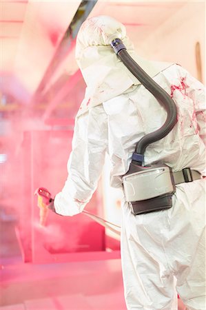 spray painting safety equipment - Worker painting steel red in steel factory Stock Photo - Premium Royalty-Free, Code: 6113-08655272