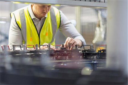 fabrication - Worker examining machinery in steel factory Stock Photo - Premium Royalty-Free, Code: 6113-08655276