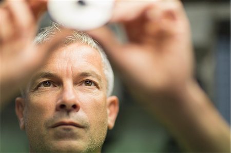 Focused worker examining part in steel factory Stock Photo - Premium Royalty-Free, Code: 6113-08655283