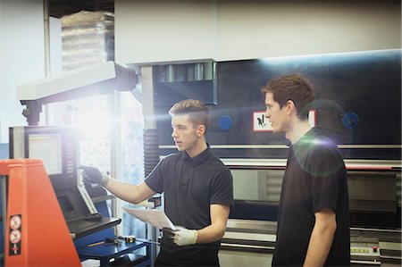 Worker training trainee at machinery control panel in steel factory Stock Photo - Premium Royalty-Free, Code: 6113-08655286