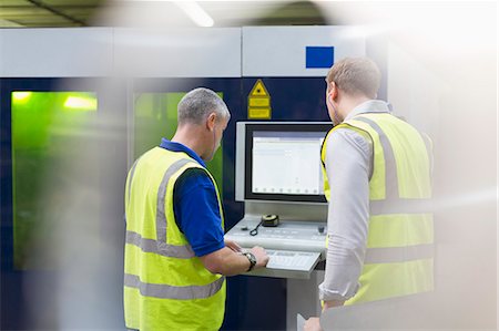 Workers at machinery control panel in steel factory Stock Photo - Premium Royalty-Free, Code: 6113-08655289