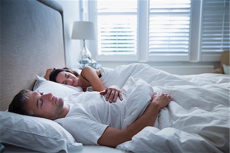 sleeping couple on the bed - Serene couple sleeping in bed Stock Photo - Premium Royalty-Free, Code: 6113-08655384