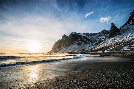 Sun setting over tranquil beach and snowy mountain, Iceland Stock Photo - Premium Royalty-Free, Code: 6113-08655492